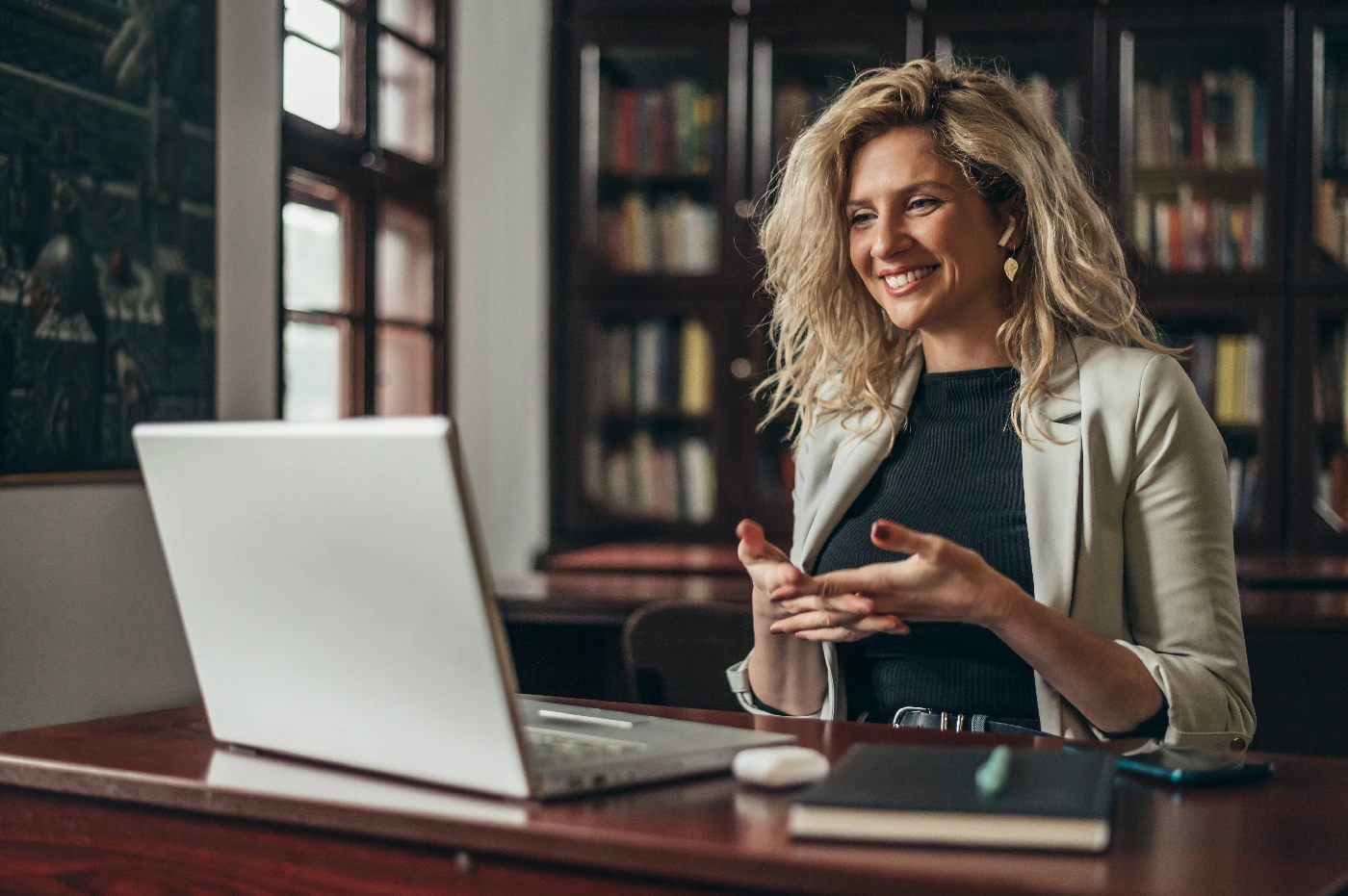 Smiling professional woman with laptop in office